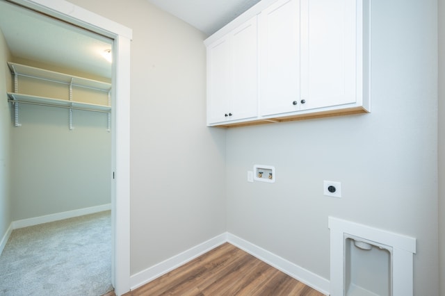 clothes washing area featuring hookup for a washing machine, cabinets, wood-type flooring, and hookup for an electric dryer