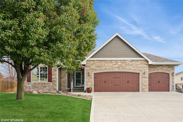 view of front of home with a garage and a front lawn