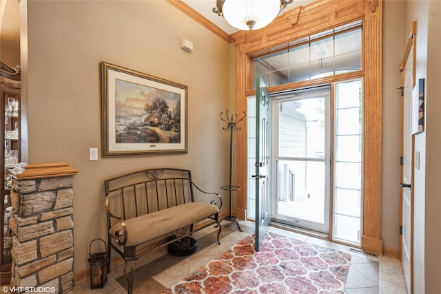 tiled entryway featuring ornamental molding