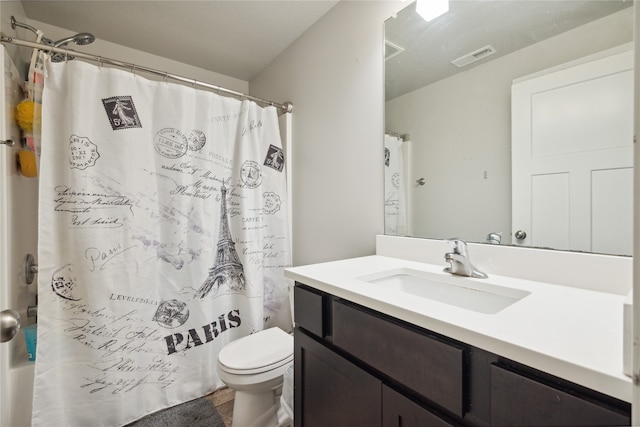 bathroom featuring a shower with curtain, vanity, and toilet