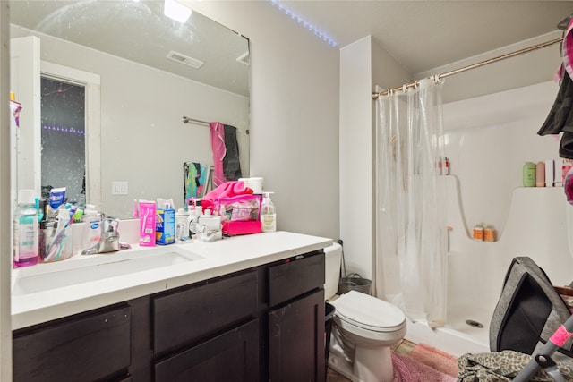 bathroom featuring toilet, vanity, and a shower with shower curtain