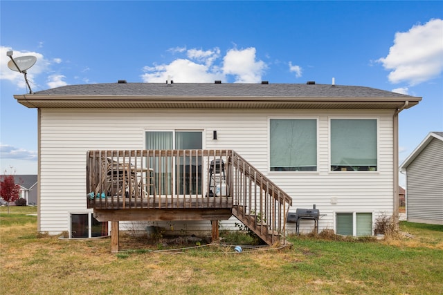 rear view of house with a deck and a yard