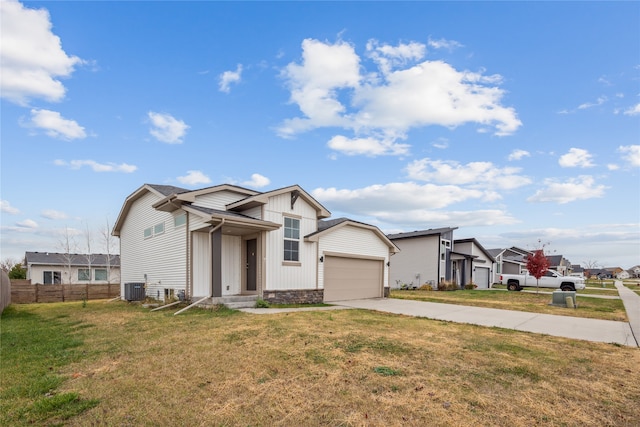 view of front facade featuring a garage, central AC unit, and a front yard