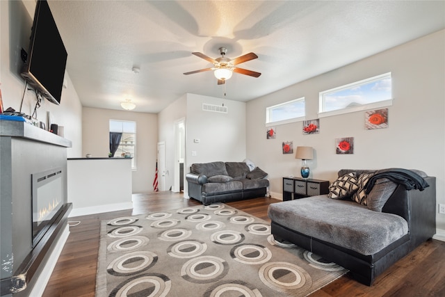 living room featuring dark hardwood / wood-style flooring and ceiling fan