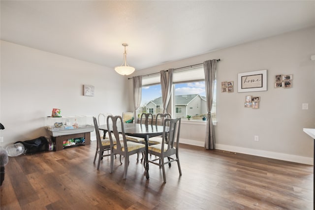 dining space with dark hardwood / wood-style flooring