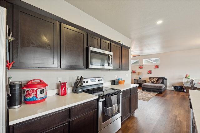 kitchen featuring dark brown cabinetry, appliances with stainless steel finishes, dark hardwood / wood-style floors, and ceiling fan