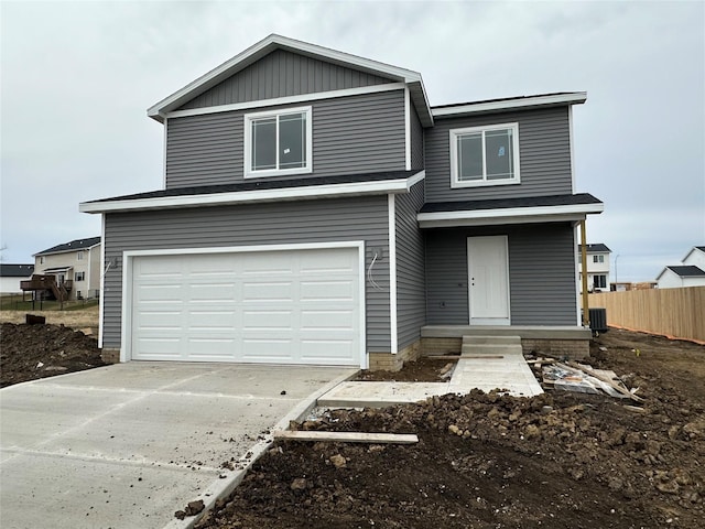 view of property featuring a garage and cooling unit