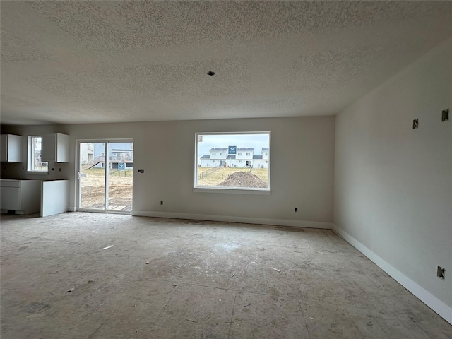 unfurnished living room featuring a textured ceiling