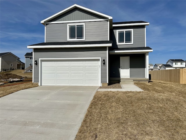 view of front of house with concrete driveway, a garage, and fence