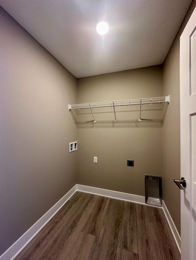 washroom featuring baseboards, hookup for an electric dryer, dark wood-style floors, and laundry area