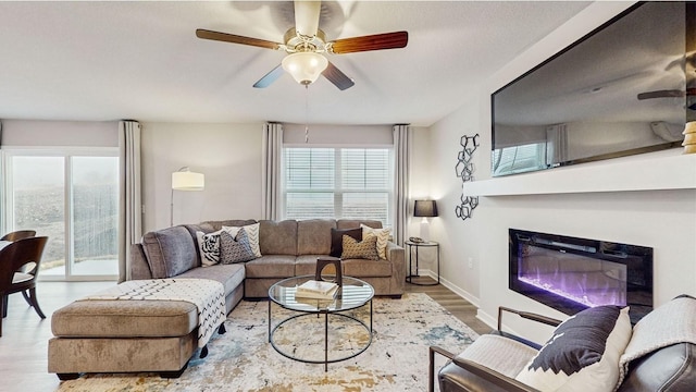 living room with ceiling fan and light hardwood / wood-style flooring