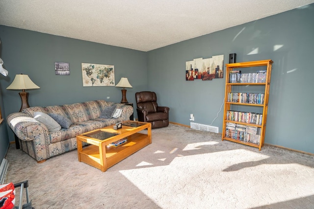 living room featuring a textured ceiling and carpet floors