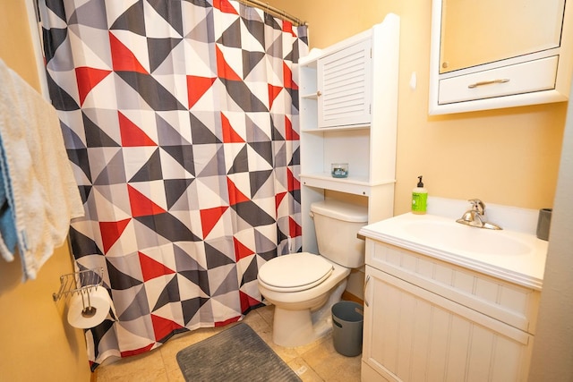 bathroom with tile patterned flooring, vanity, and toilet