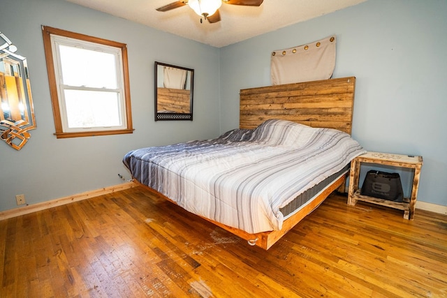 bedroom with hardwood / wood-style flooring and ceiling fan