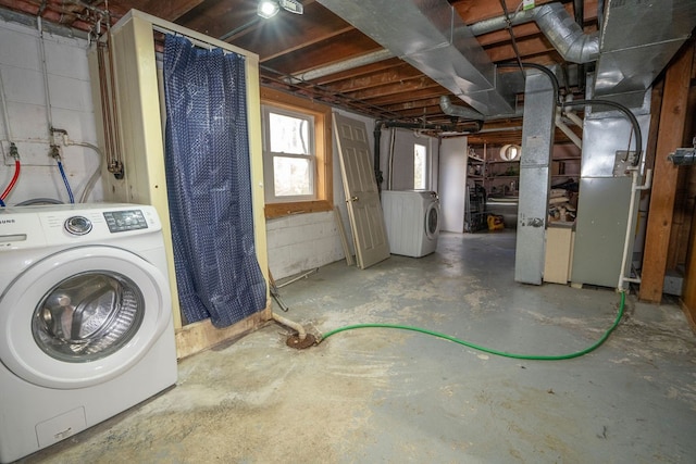 basement with heating unit and washer / dryer