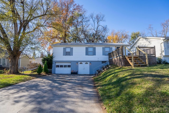 view of front of house featuring a garage, a front yard, and a deck