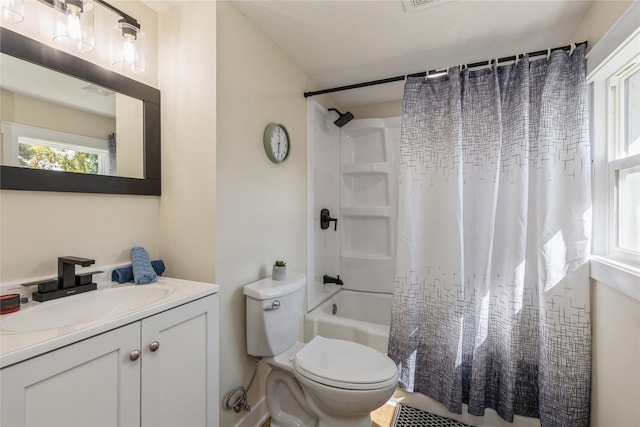 full bathroom featuring vanity, shower / bath combo with shower curtain, and toilet