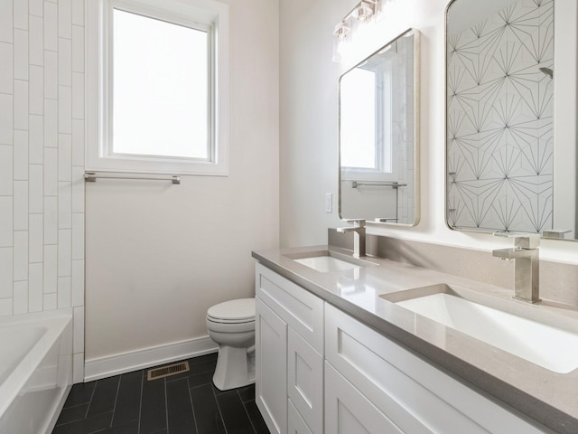 18176 Alderleaf Dr, Clive, IA 50325 - bathroom featuring toilet, tile patterned floors, double vanity, and baseboards