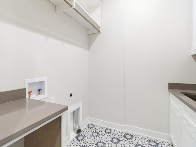 18176 Alderleaf Dr, Clive, IA 50325 - laundry room featuring electric dryer hookup, cabinet space, baseboards, and hookup for a washing machine