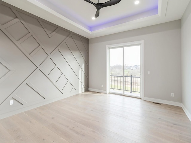 18176 Alderleaf Dr, Clive, IA 50325 - spare room featuring baseboards, ceiling fan, a tray ceiling, light wood-style flooring, and recessed lighting