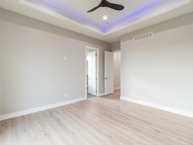18176 Alderleaf Dr, Clive, IA 50325 - unfurnished room featuring a tray ceiling, light wood-type flooring, baseboards, and recessed lighting