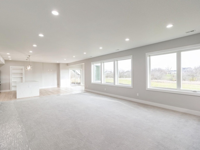 18176 Alderleaf Dr, Clive, IA 50325 - unfurnished living room featuring baseboards, recessed lighting, and light carpet
