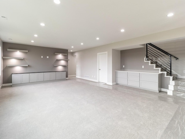 18176 Alderleaf Dr, Clive, IA 50325 - unfurnished living room with baseboards, recessed lighting, stairs, and light carpet