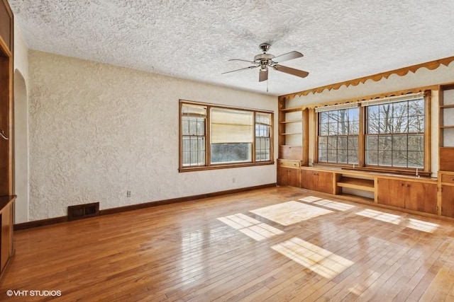 empty room featuring ceiling fan and light wood-type flooring