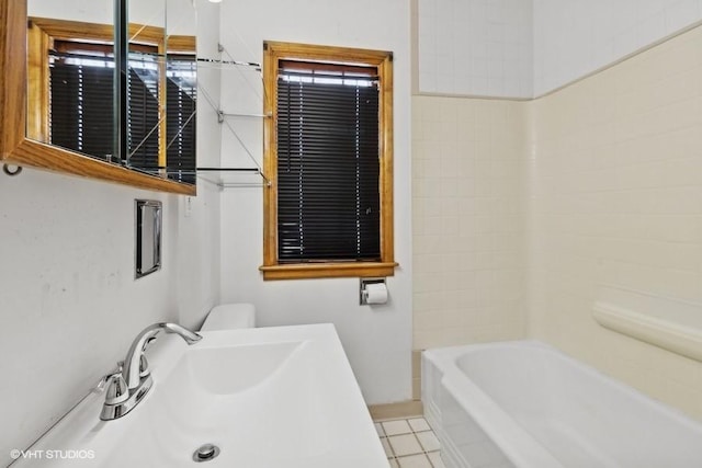 bathroom featuring sink, tile patterned floors, and toilet