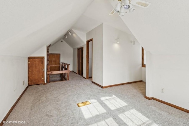 bonus room featuring ceiling fan, vaulted ceiling, and light carpet