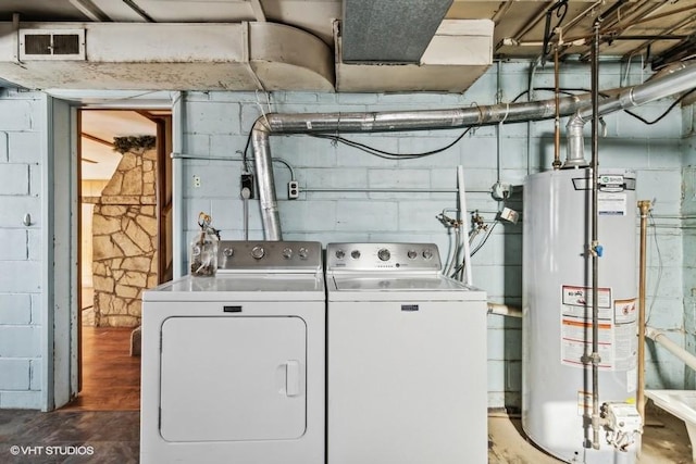 clothes washing area with water heater and washing machine and clothes dryer