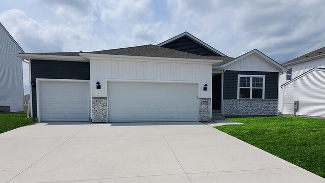 view of front facade with a front yard and a garage