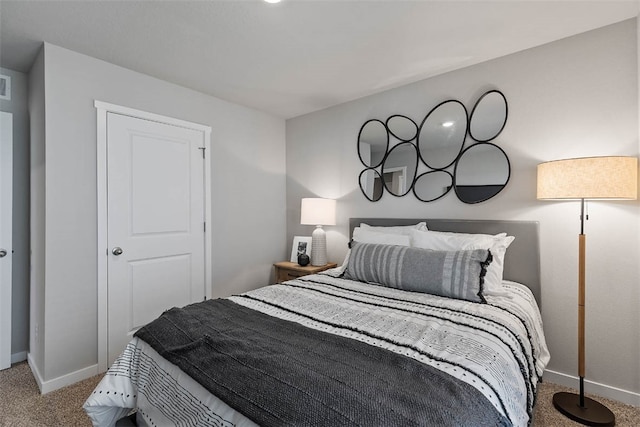 bedroom featuring carpet floors, visible vents, and baseboards