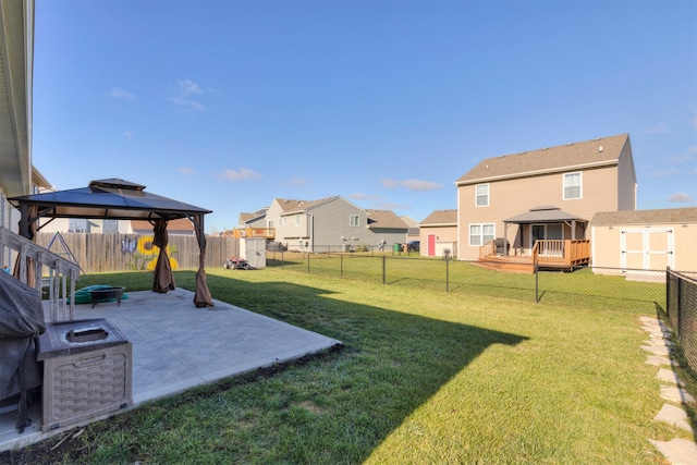 view of yard with a deck, a shed, a patio, and a gazebo