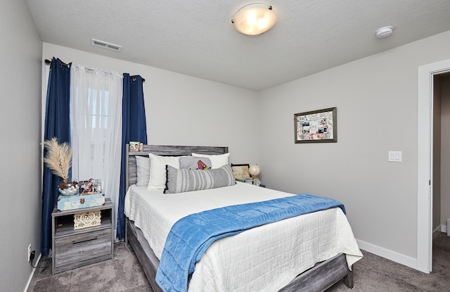 carpeted bedroom with a textured ceiling