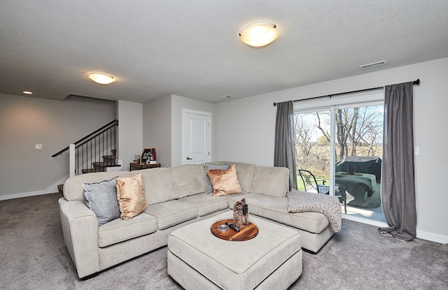 carpeted living room with a textured ceiling