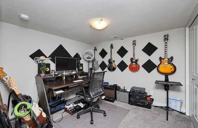 office space with a textured ceiling and light carpet