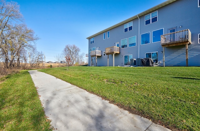 rear view of house featuring a lawn