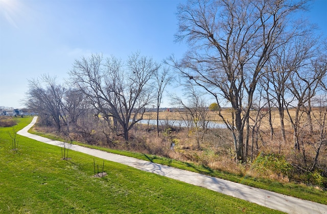 view of property's community featuring a water view and a lawn