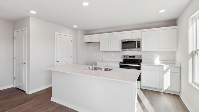 kitchen featuring dark hardwood / wood-style floors, an island with sink, white cabinetry, sink, and stainless steel appliances