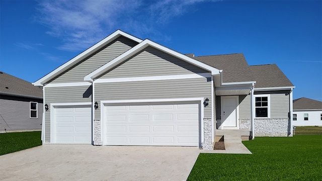 single story home featuring an attached garage, stone siding, concrete driveway, roof with shingles, and a front yard