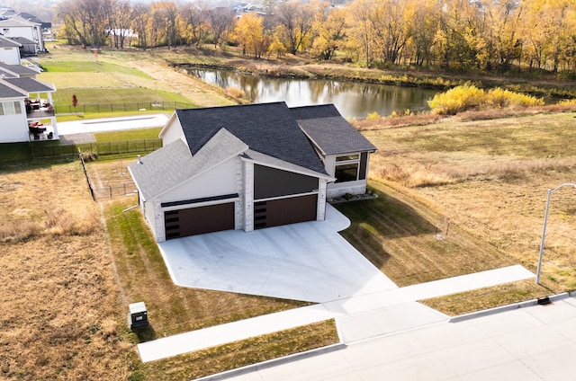 birds eye view of property with a water view