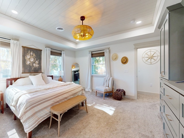 bedroom featuring a tray ceiling, wood ceiling, light colored carpet, and a notable chandelier