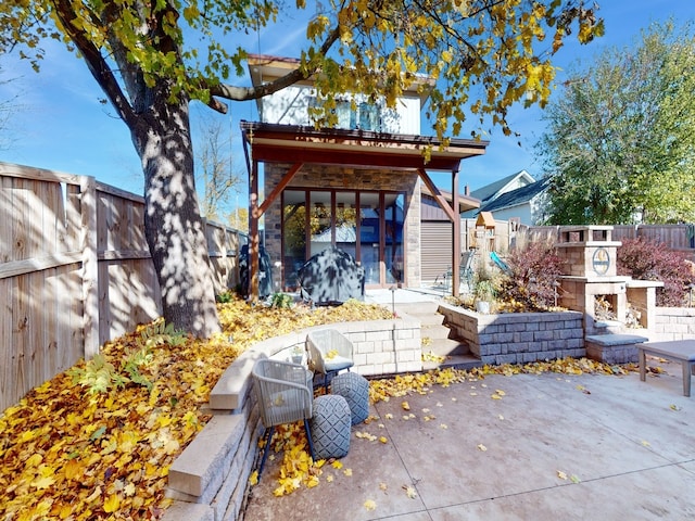 view of patio / terrace with a storage shed and an outdoor fireplace