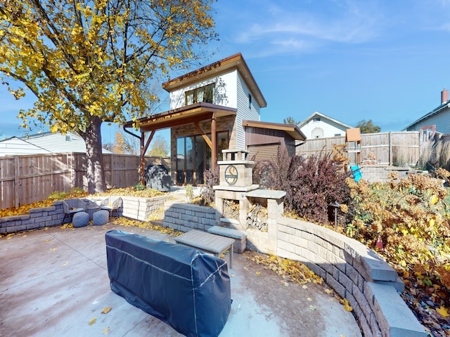 view of patio with an outdoor living space with a fireplace