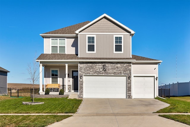 view of front of house with a garage, a porch, and a front lawn