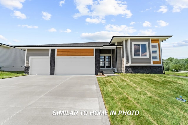 view of front of home with a garage and a front yard