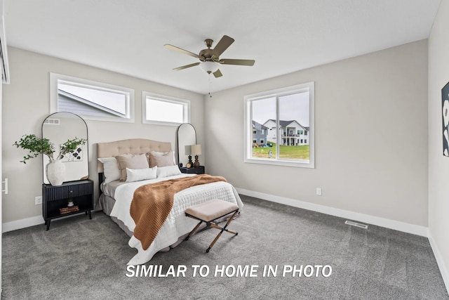 carpeted bedroom featuring a ceiling fan, visible vents, and baseboards