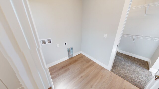 washroom featuring hookup for a washing machine, baseboards, hookup for an electric dryer, and light wood-type flooring