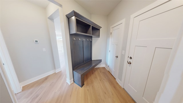 mudroom with baseboards and light wood finished floors